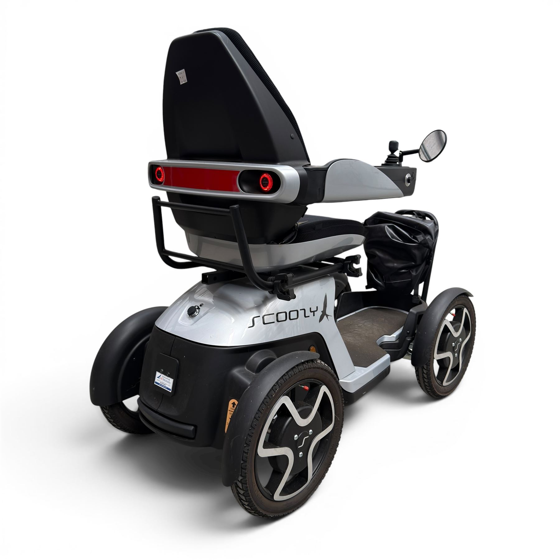 TGA Scoozy - mobility scooter, four wheel model with joystick controls, front storage bag, lights and grey and black bodywork.
