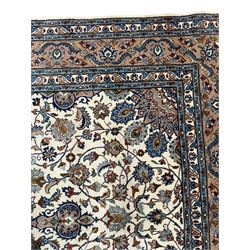 Persian Kashan ivory ground rug, the central medallion surrounded by an arrangement of palmettes united by scrolling leafy branches, peach ground main border decorated with trailing leaf and stylised plant motifs, floral pattern guard stripes 