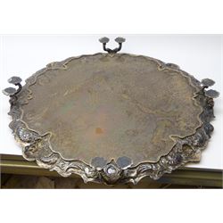 Large and impressive early 20th century Georgian style silver salver, the cast C scroll border detailed with four masks with fruiting vines, flowers and wheat ears, upon four twin scrolling feet with flower head pads, hallmarked Elkington & Co Ltd, Birmingham 1931, D55.5cm, weight 157.66 ozt (4904 grams), with oak stand 
