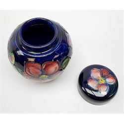 Three pieces of Moorcroft pottery, comprising bowl decorated in the Orchid pattern upon a green glazed ground, D19cm, and vase and ginger jar decorated in the Anemone pattern, each with impressed marks beneath, one with painted mark, and another with paper label remnants. (3).