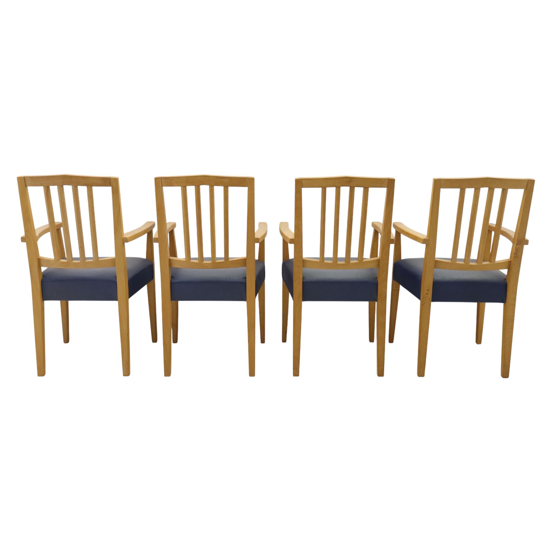 Modern twelve oak dining chairs including one 'Chairmans' chair, solid oak construction, slatted back and arm rests, blue leatherette padded seat, on tapered square supports 