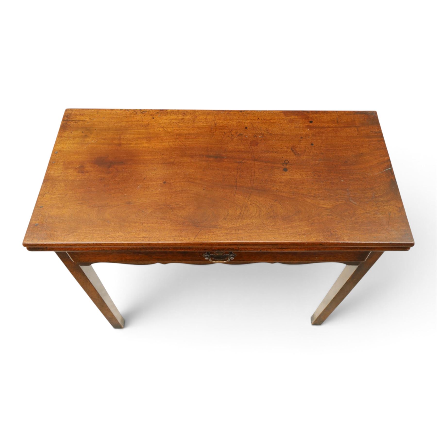 Georgian oak tea table, rectangular fold-over top above single frieze drawer with brass swing handle, shaped apron, gateleg raised on square tapering supports