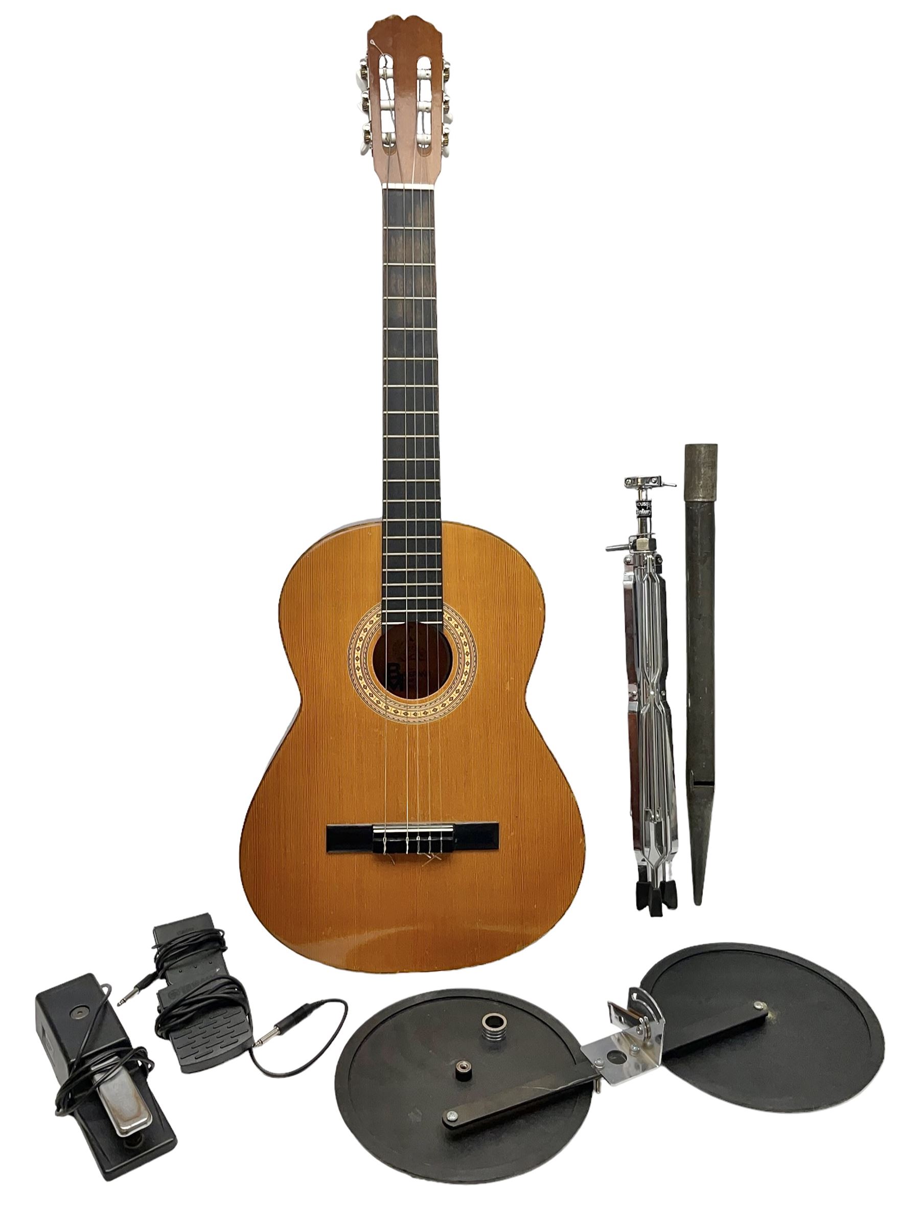 Spanish BM acoustic guitar with mahogany back and sides and spruce top L101cm; in cello carrying case; Roland foot pedal and two Yamaha foot pedals; tin D# organ pipe; folding music stand etc