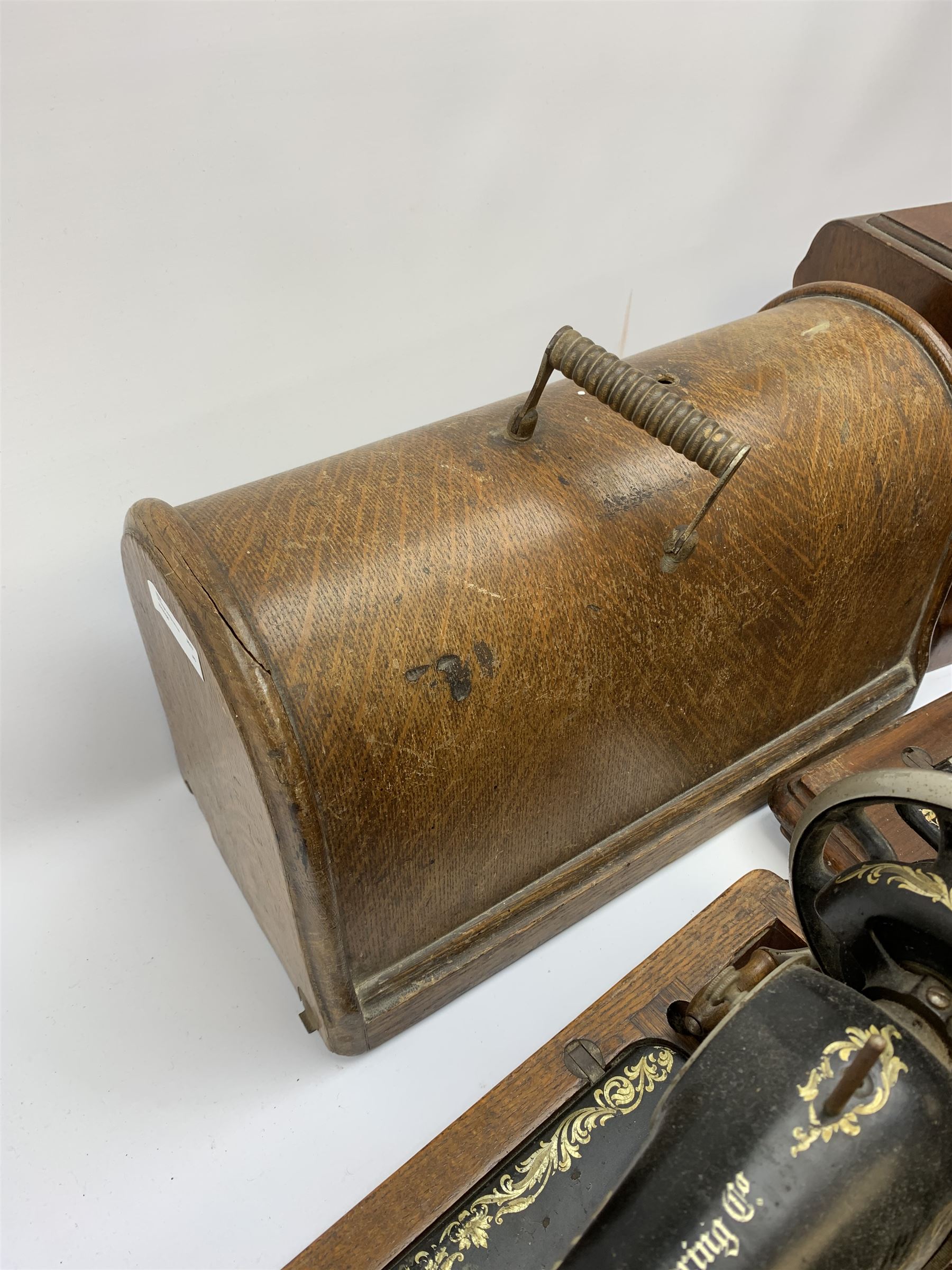 Two vintage sewing machines, the first marked Federation, in mahogany case, the second marked Singer, in oak case. 