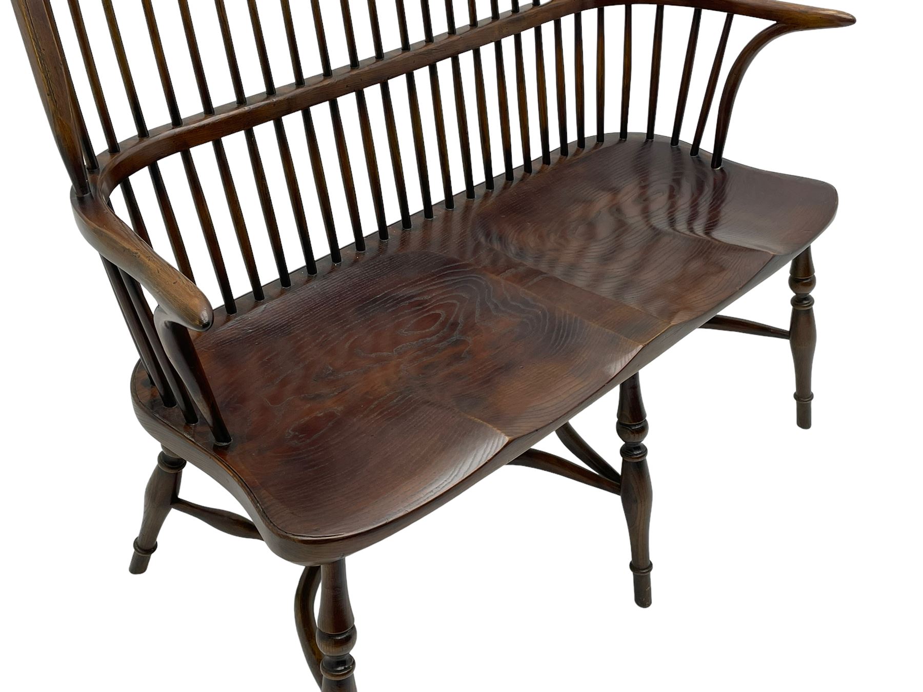 Traditional elm and oak two seat Windsor bench, high comb and stick back, double dished seat on turned supports joined by two crinoline stretchers