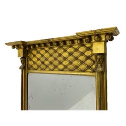 Regency period giltwood and gesso pier glass mirror, projecting globular cornice over basket lattice frieze, two half column pilasters with Egyptian mask capitals enclosing bevelled plate