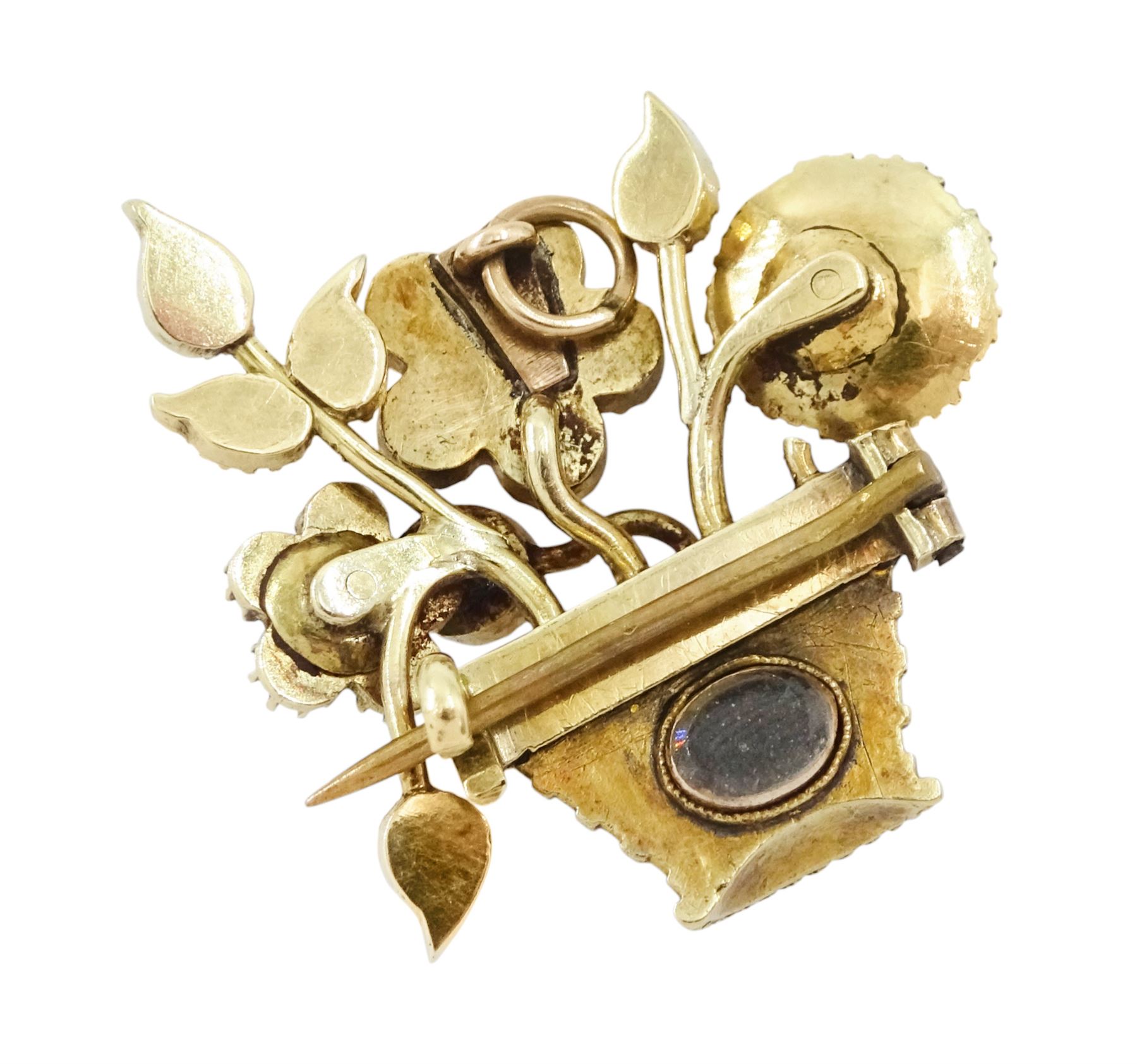 19th / 20th century gold multi gemstone set flower basket brooch, the flowers set with garnets, amethysts, seed pearls and turquoise, in a seed pearl woven basket, with a glazed back