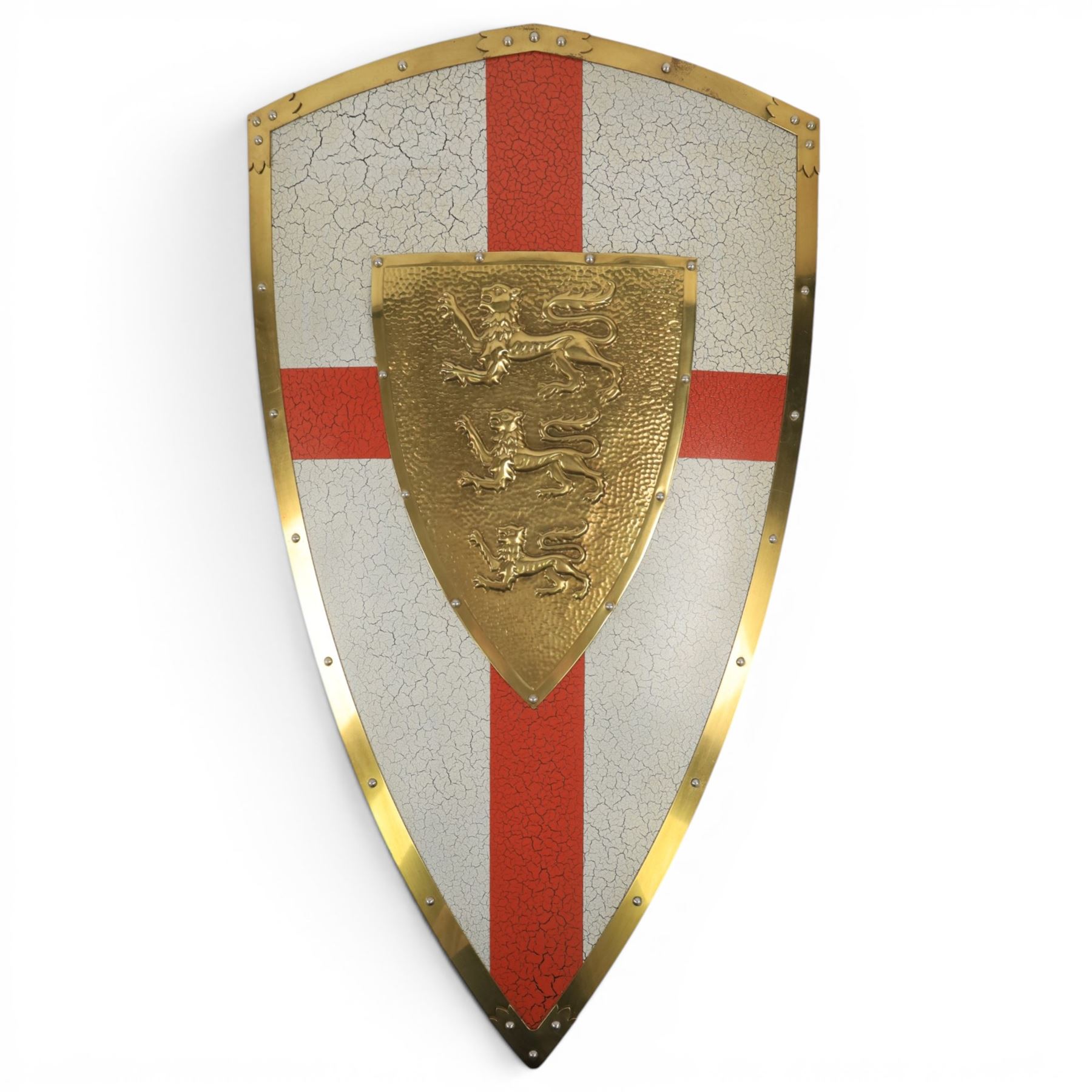 Five wall hangings, modelled as shields, decorated to the centre in relief with three lions 