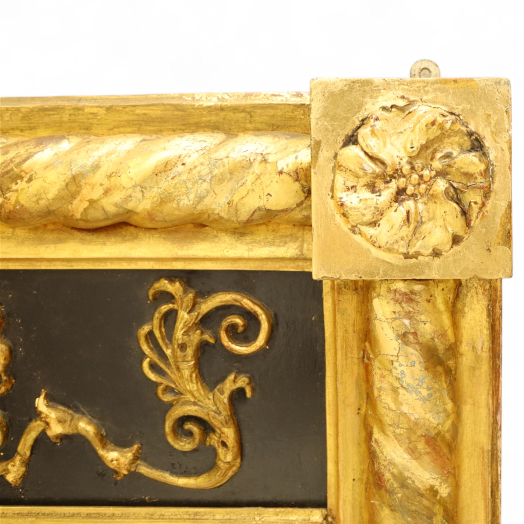 19th-century Regency-style ebonized and giltwood pier mirror, rectangular form frame with twisted rope columns on either side, ebonized frieze panel decorated with gilt applique scrollwork and central anthemion and arabesques
