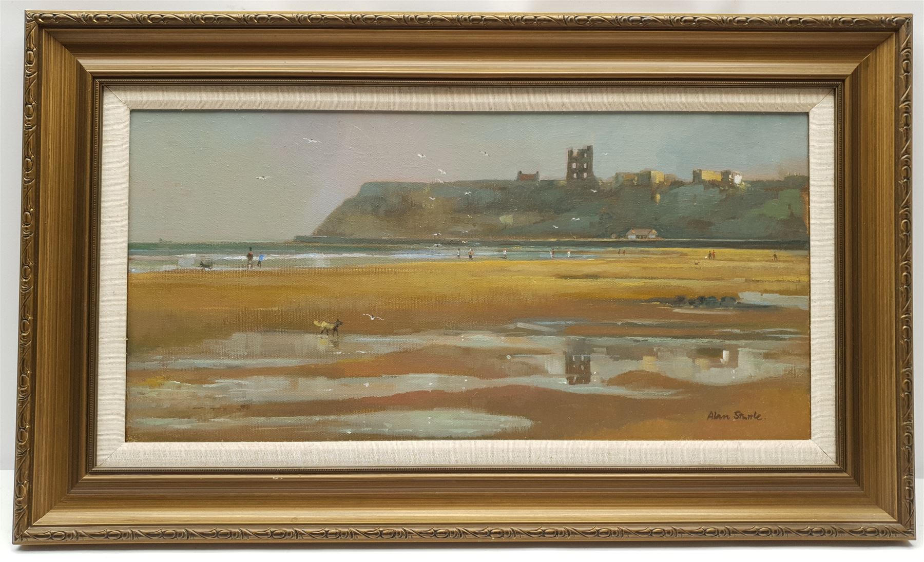 Alan Stuttle (British 1939-): Seagulls over 'Scarborough' North Bay, oil on canvas signed, titled and dated 1989 verso 24cm x 50cm