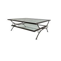 Wrought metal coffee table, curved x-framed base with glass inset top and undertier 