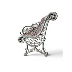 Large late Victorian cast iron garden bench, serpentine form with scroll back and seat, slatted with mahogany stained Sapele