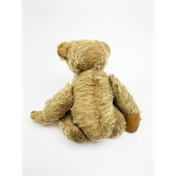 Rare early 20th century teddy bear c1920, possibly Chiltern/Einco or Harwin, mohair covered with wood wool filled humped back body with jointed limbs, cotton twill paw pads and vertically stitched nose with unusual W-shaped stitched mouth H15