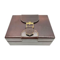 Rolex brown leather box, with decorative buckle to cover, opening to reveal wooden veneer interior, the inside lid stamped in gilded lettering 'Creation Genève Rolex', stamped beneath 'Montes Rolex S.A. Geneve Swiss 71.00.04, H8cm