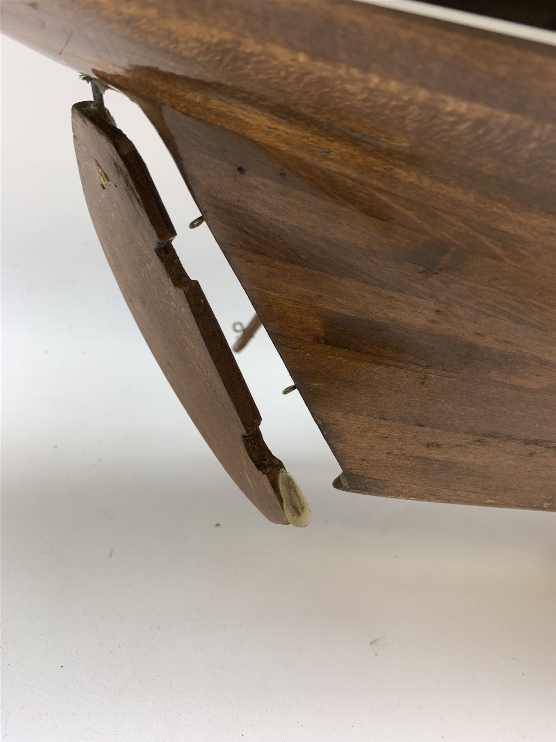 Pond yacht with part black painted mahogany hull and keel, working rudder and mast with three sails W90cm H95cm, loose mounted on mahogany stand