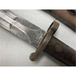 British No 7 MKI knife bayonet with 20cm single edged fullered clipped point blade;  blackened steel, large muzzle ring cross-guard; blackened swivelling pommel marked 'F5H'; red Tufnol composite grips; in blackened steel scabbard L33cm overall; British Pattern 1888 bayonet with scabbard; and German Ersatz bayonet with scabbard (3)