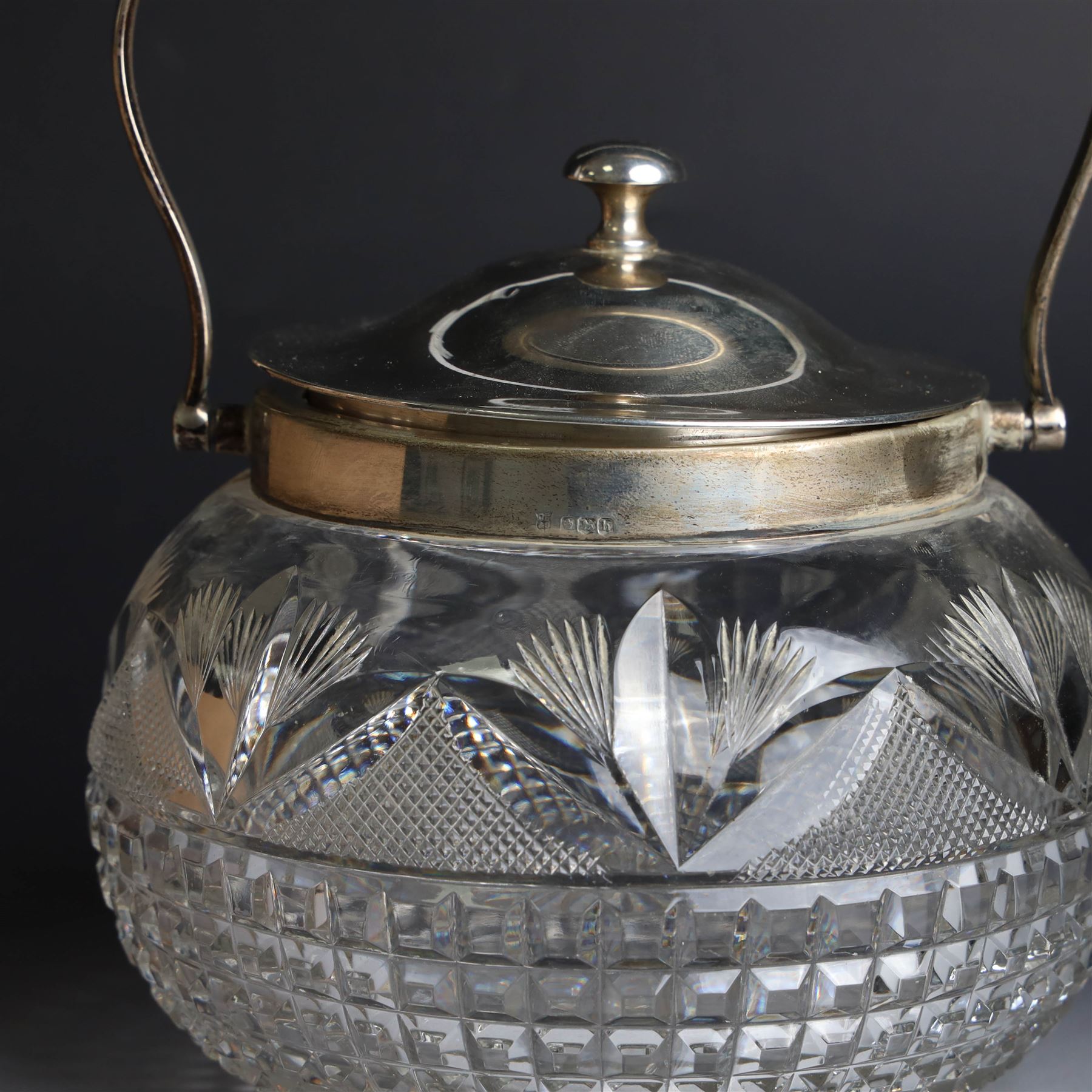 1920s silver mounted cut glass biscuit barrel, the ovoid glass body with square and hobnail cut decoration, with silver lid, collar and swing handle, hallmarked Cooper Brothers & Sons Ltd, Sheffield 1925, H15cm