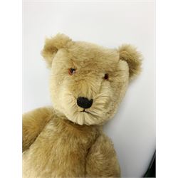 Chiltern Hugmee large teddy bear c1950s with kapok filled long-plush body, jointed swivel head with original orange and black glass eyes and vertically stitched nose and mouth, jointed limbs with card lined feet and velvet covered pads and inoperative squeaker H22