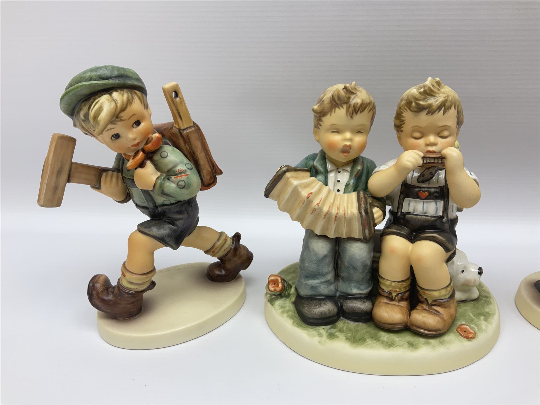 Twenty five Hummel figures by Goebel, to include Tuning up, Blessed Event, Book Worm, The Little Architect etc 