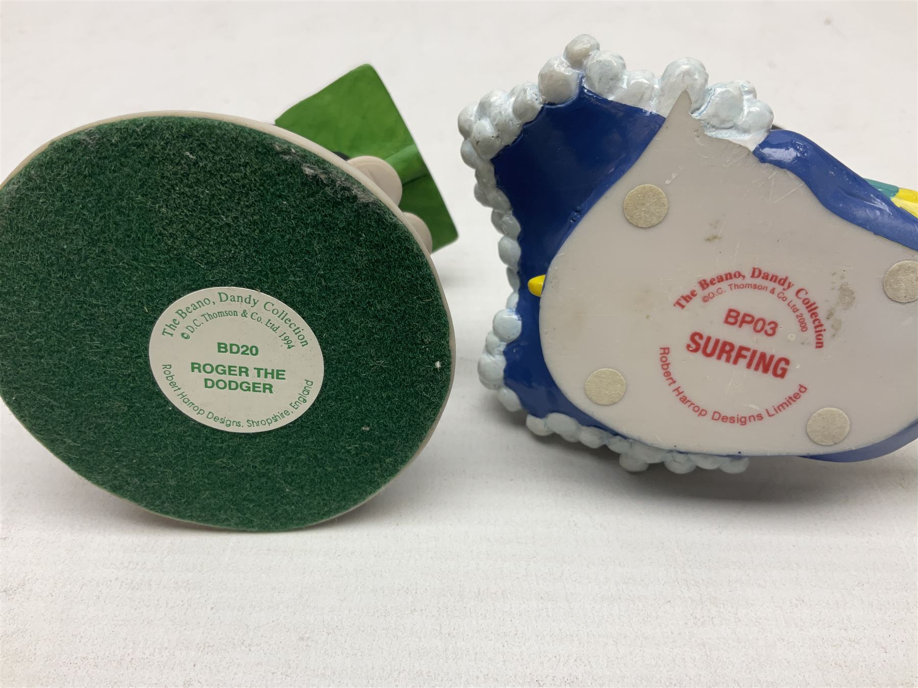 Eleven Robert Harrop figures from the Beano Dandy collection, comprising One Man & His Dawg BDS08, Picnic Desperate Dan BDS04, Fatty BD07, Desperate Dan BD03, Roger the Dodger BD20, Dennis the Menace BD01, Beryl the Peril BD05, Minnie the Minx BD04, Surfing BP03, two Spotty BD16, together with a Genuine Beano Ware lidded box (12)