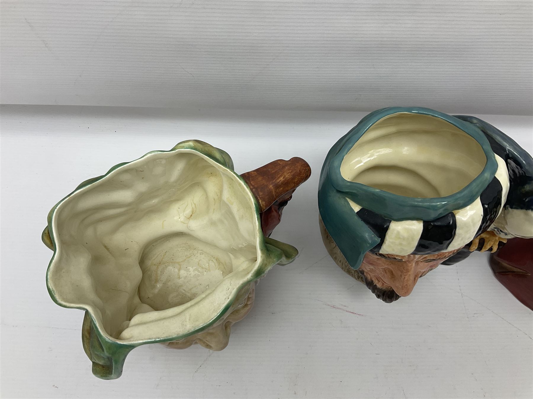 Collection of Royal Doulton and Beswick character jugs of various sizes, including North American Indian D6611, The Falconer D6533,  Tony Weller 281, Sairey Gamp 371 etc