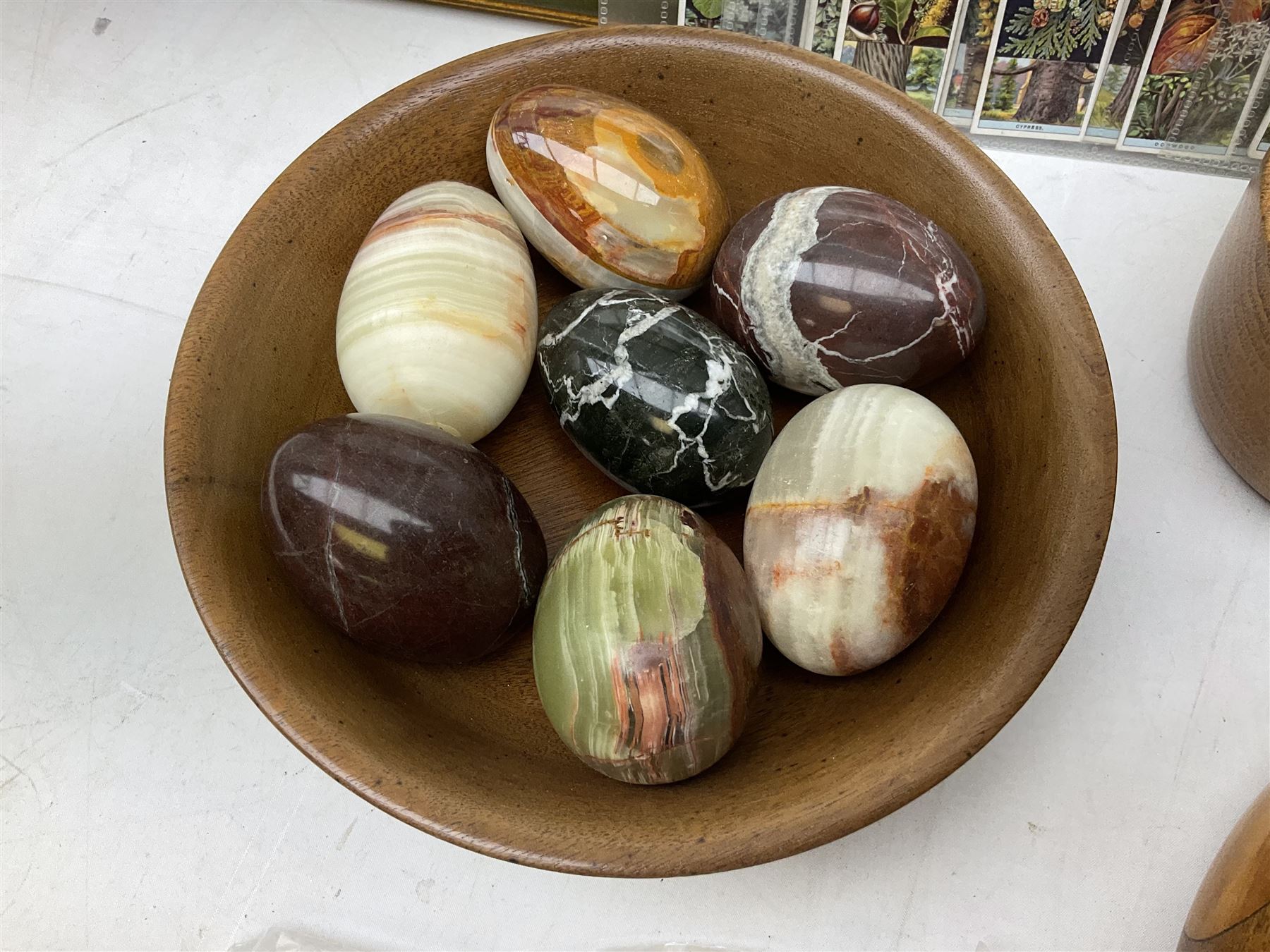 Quantity of cigarette cards to include three frames, and quantity of marble and agate eggs, turned wood bowls etc