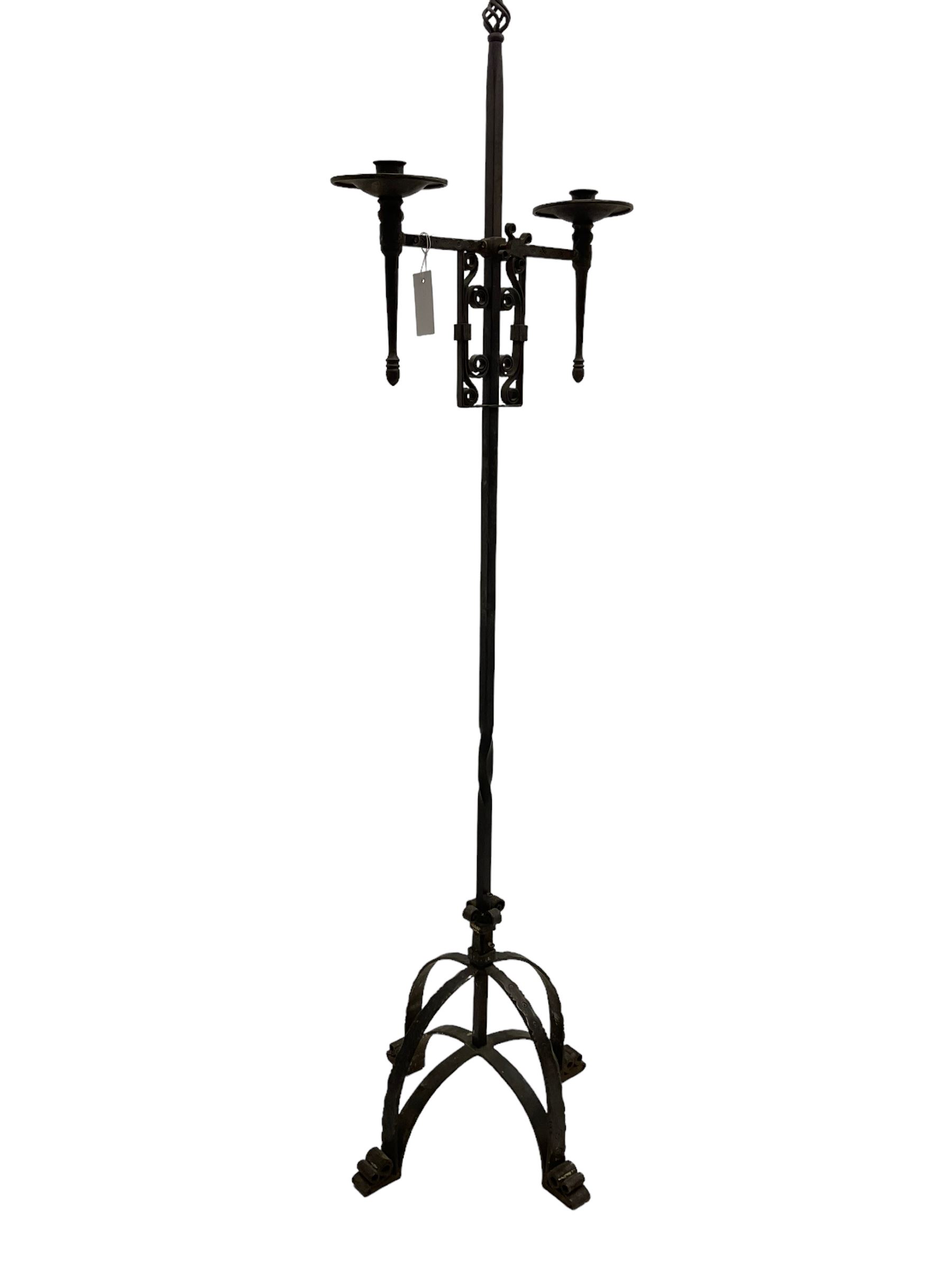 Ironwork candle holder stand, with stamped decoration, adjustable two branch sconces with scrolled iron work, twist stem with arched supports with scrolled terminals