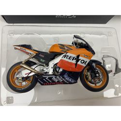 Three Ixo Models 1:12 scale die-cast models of motorcycles - BRB007 Honda NSR500 Michael Doohan 1998; BRB001 Honda RC211V Valentino Rossi 2003; and Yamaha YZR-M1 Colin Edwards MotoGP Phillip Island 2007; all boxed (3)