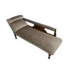 Edwardian carved stained beech chaise longue, the back support and scrolled end carved with foliate decoration,upholstered in pale lilac fabric with sprung seat, on turned supports