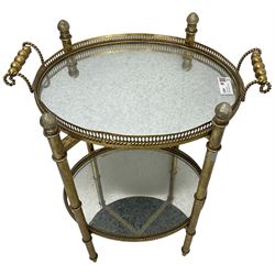 Gilt metal oval stand, two mirrored tray tiers with raised pierced galleries