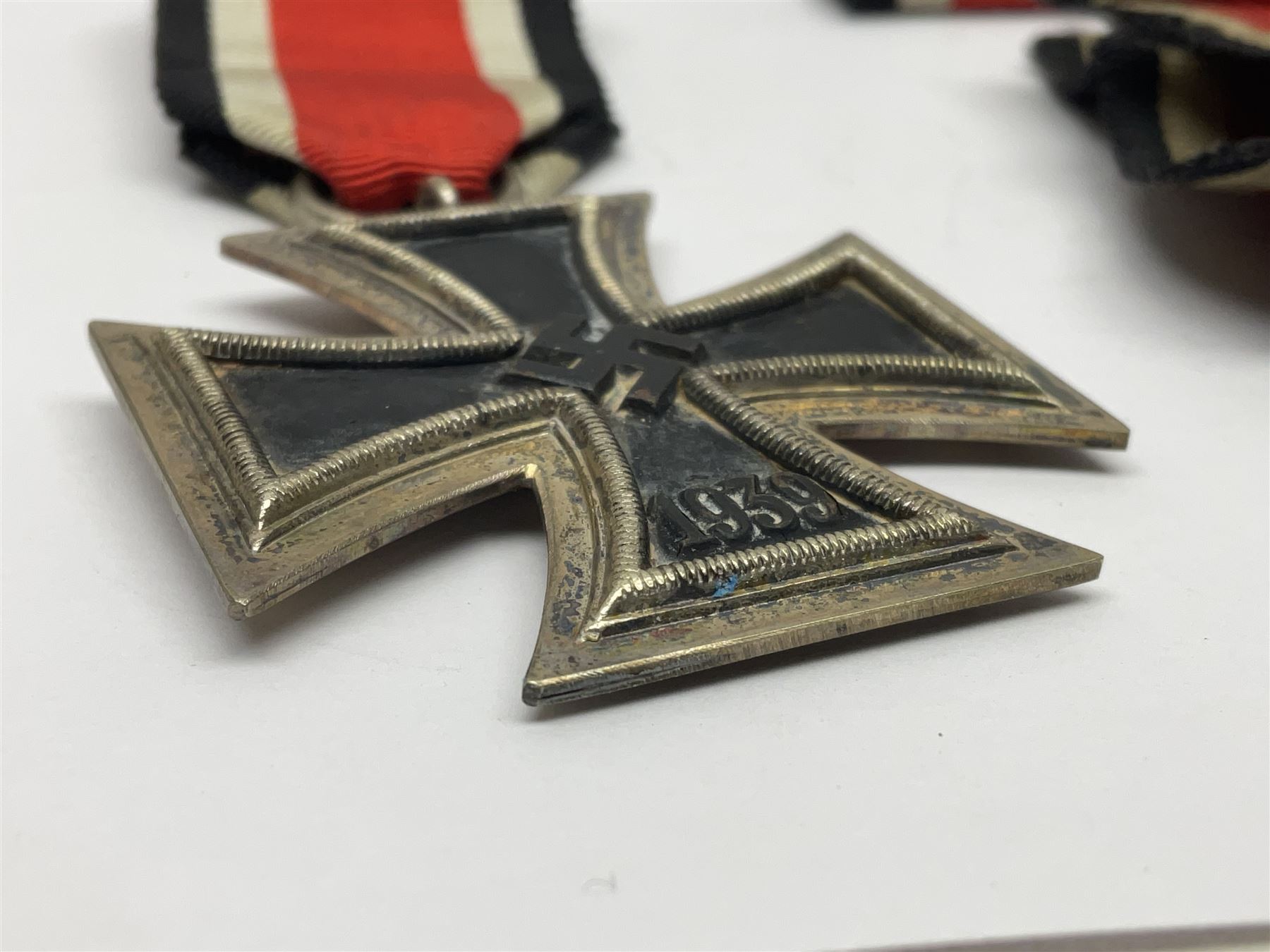 WWII German Iron Cross 2nd Class, the suspension ring stamped 128 for S. Jablonski G.m.b.H. Posen; with ribbon; together with an embroidered cloth eagle badge and quantity of German medal ribbons.