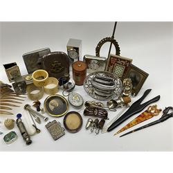 A group of assorted collectables, to include small oval purple guilloche enamel frame, WWII matchbox holder depicting Winston Churchill, Halcyon Days enamel box, Ronson table lighter, ebonised glove stretchers, ivory napkin ring, mother of pearl handled button hook, engine turned cigarette case, etc. 
