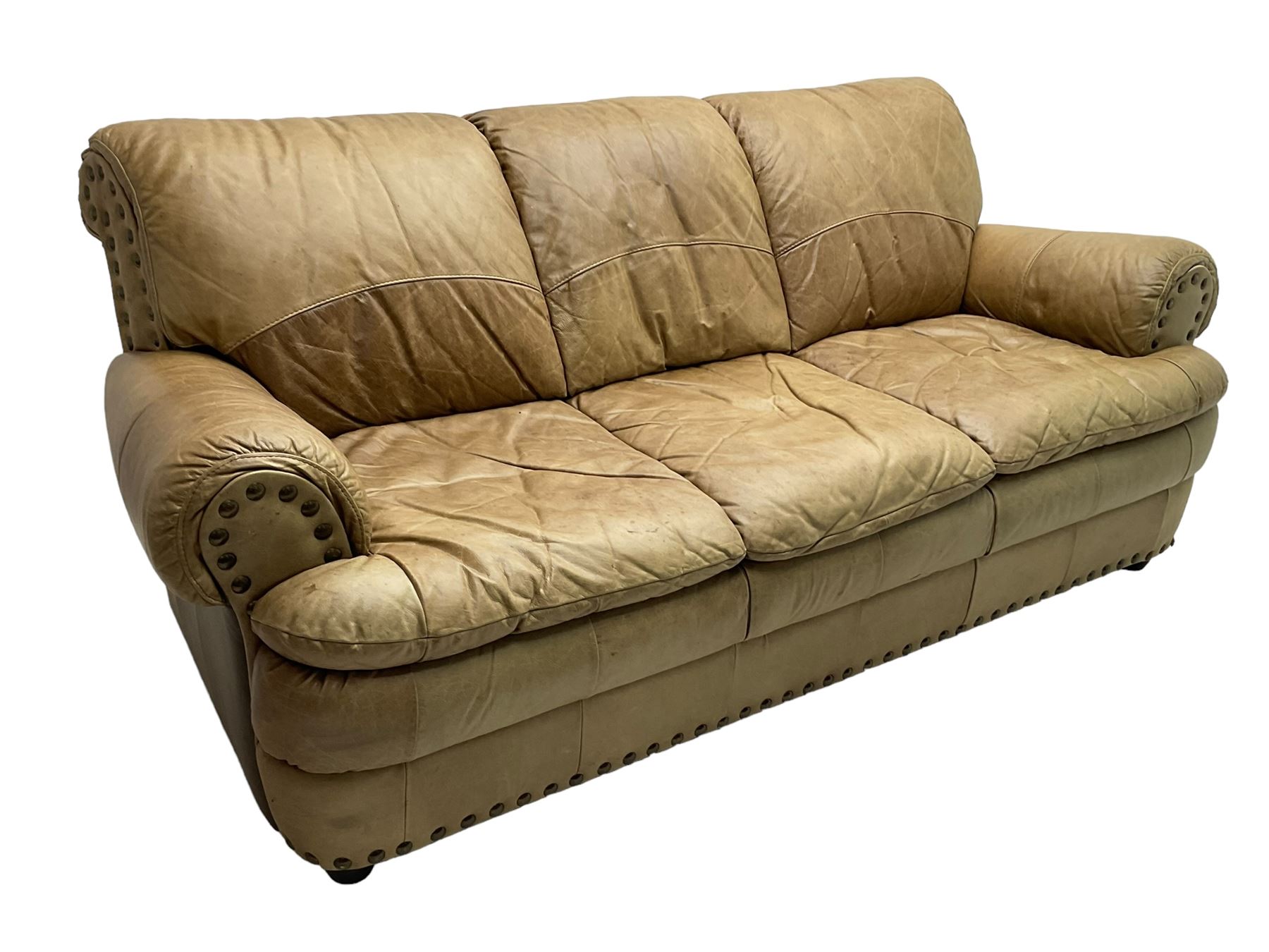 Large three-seat sofa upholstered in stitched brown leather with stud work decoration, rolled back and arms