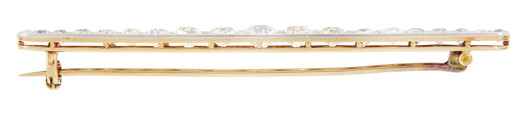 Early 20th century gold and platinum milgrain set graduating old cut diamond brooch, with diamond accents set between, principal diamond approx 0.65 carat, total diamond weight approx 4.75 carat