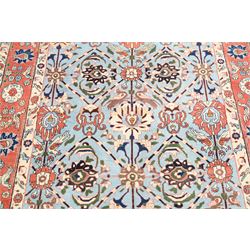 Persian Tabriz cyan ground rug of Benlian design, the field decorated with large palmette motifs, the crimson and ivory guard lines with repeating bird of paradise and interspersed stylised plant motifs