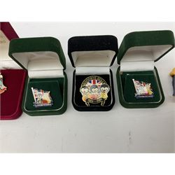 Eight ceramic Golly Band figurines marked Carlton Ware, together with four other Golly figures and five boxed badges