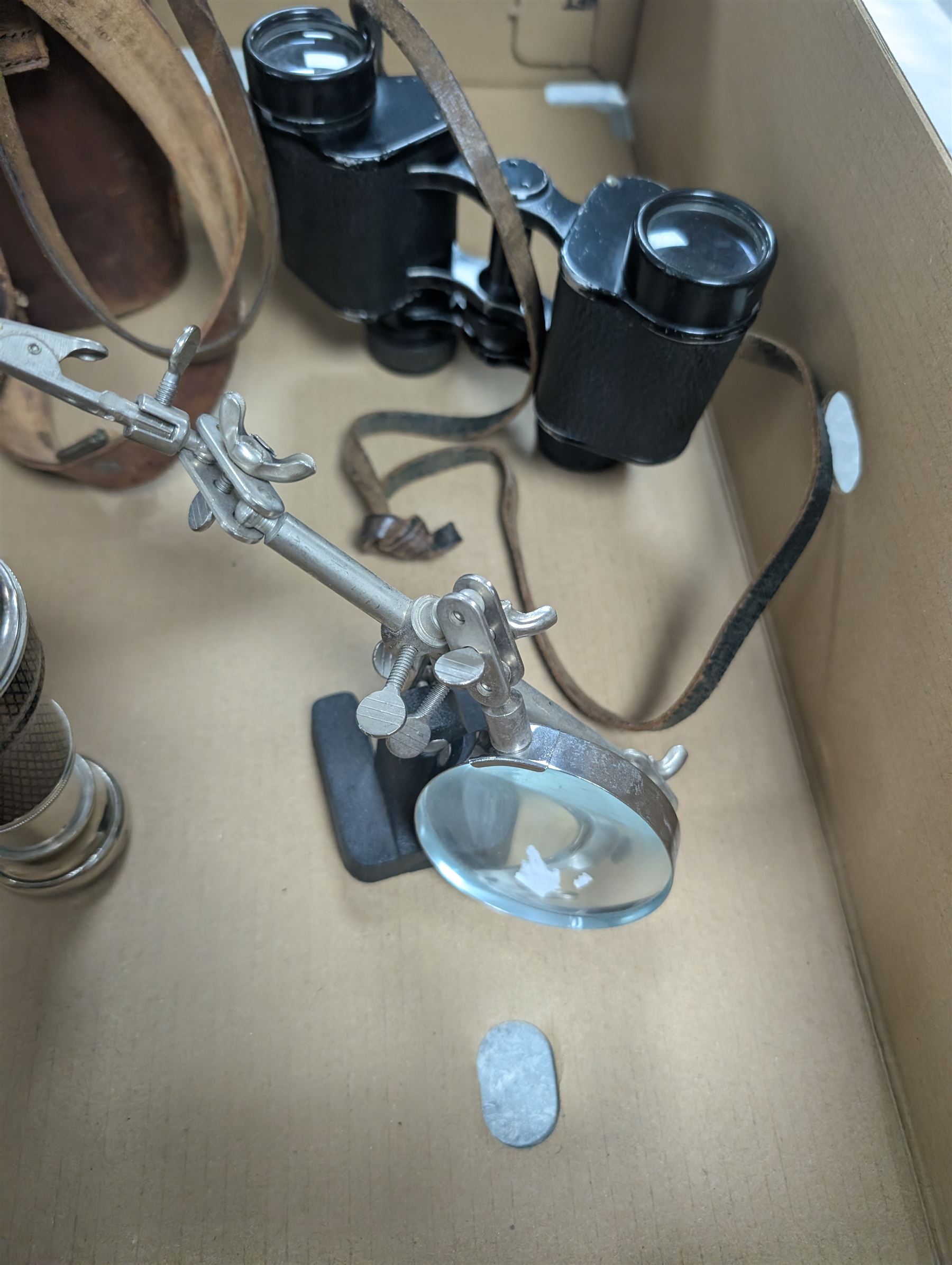 Three pairs of binoculars including Wrayvu 8x30 and Busch Hellux, together with a tabletop magnifying glass