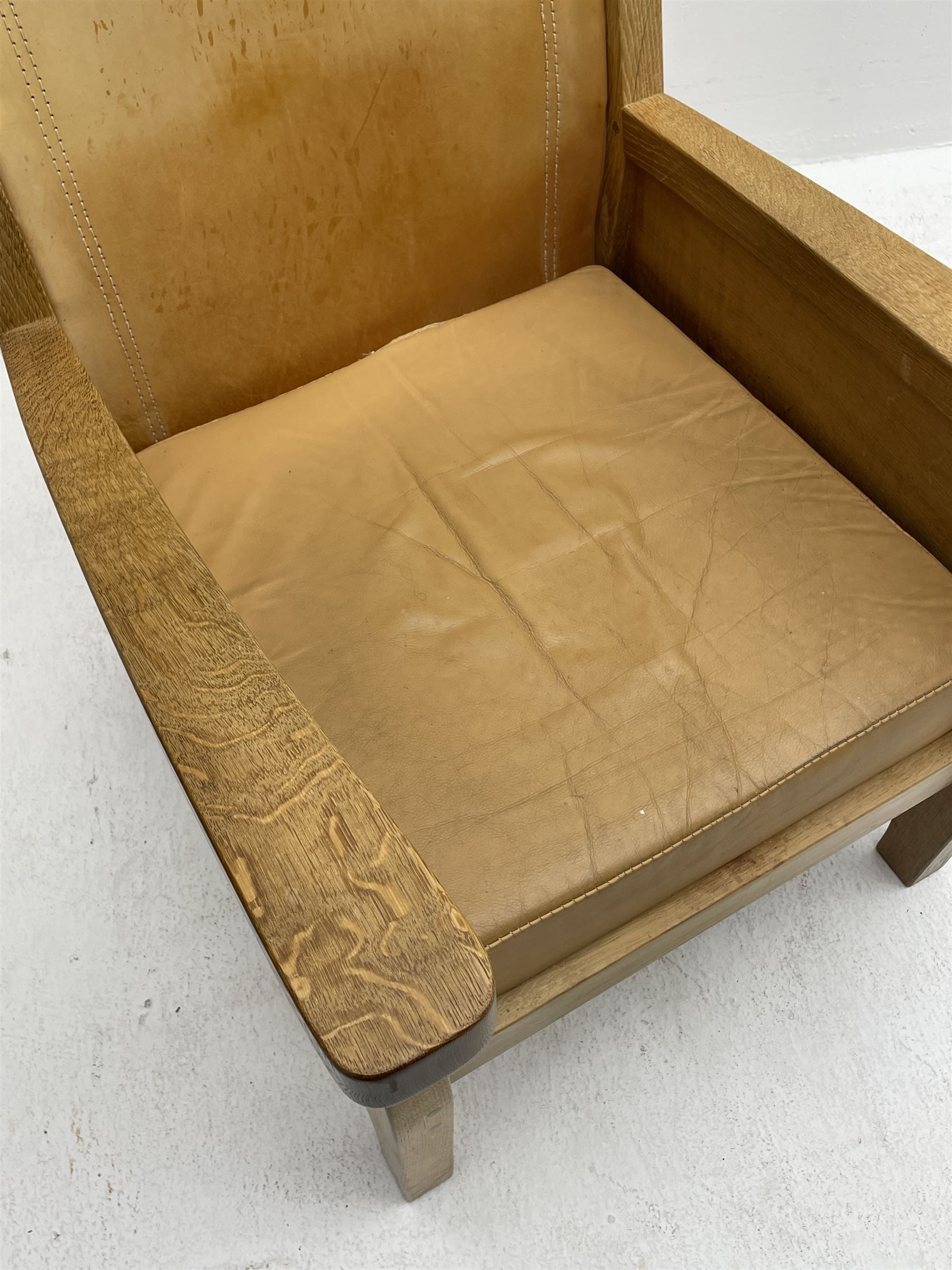 'Mouseman' oak smokers armchair, panelled sides, slung tan leather back and upholstered seat cushion, by Robert Thompson of Kilburn