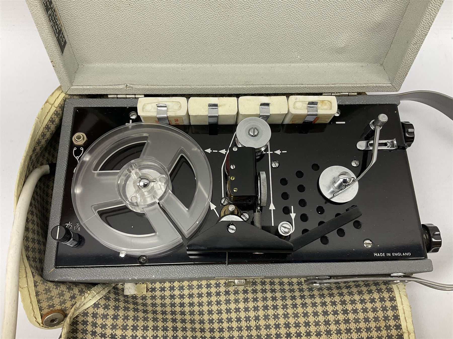 John Lennon interview recording conducted by John Hill student of Hull University on the 16th October 1964 at the A.B.C. Theatre Hull on behalf of the university newspaper 'Torchlight'. The interview lasts eight and a half minutes. It catches John in an upbeat breezy mood answering questions about the following topics: the song writing process ('sometimes you get an idea ....I dunno....my left leg.... and then write about that....'), recording (.... 'they just say - you're recording on such and such a date and they hope we turn up with some good songs written ....'), an alternative career path (.... 'I'd probably just have been a lay-about....'), failing at college (....'some other lads did my exams for me ....'), reading matter ( Clockwork Orange, Alice in Wonderland), his books of prose, tastes in music, the Blues, The Rolling Stones, being a Beatle vis-a-vis anonymity ('Whatever I'd be I'd choose to be rich .... who wants to walk down the street?').
The interview was recorded on 1/4 inch Emitape on a Fi-Cord Fidelity Recording machine. The reel-to-reel tape comes in its original Emitape plastic box and is accompanied by the Fi-Cord reel-to-reel machine on which the interview was originally recorded. Also included in this lot are a copy of the 'Torchlight' newspaper from 21st November 1964, two photographs of the interviewer with John Lennon (the interviewer is pictured to the left of John Lennon in the photograph in which John is signing a sketch) and one photograph of Paul McCartney with another reporter, the largest measures 12 x 16.5cm and a transcript of the interview. The recording is also accompanied by the original Fi-Cord tape recorder with microphone, four original 2v batteries and battery charger. The tape recorder has been adapted to take 3xAA batteries and the 2v battery charger is fitted with a standard UK 3-pin AC plug. The interview was recorded in the press room prior to the Beatles concert at the A.B.C. Theatre and is sold with copyright.