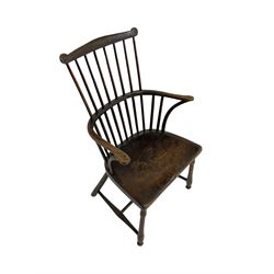 18th century country elm comb back Windsor chair, the eared cresting rail over hoop with curved arm supports, dished seat on turned supports with H stretchers
