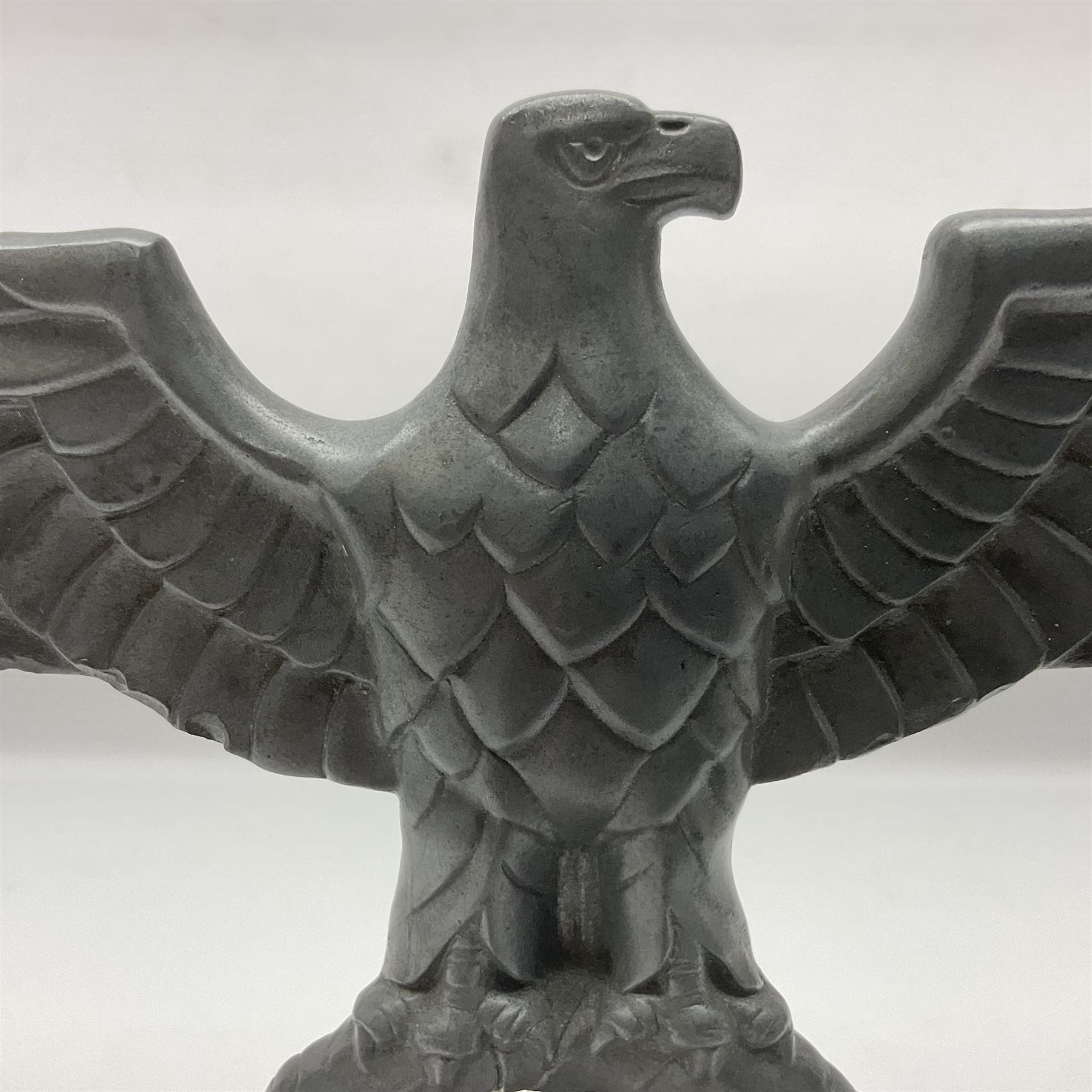 WW2 German cast white metal desk ornament/paperweight as the eagle insignia on later turned mahogany plinth H22cm