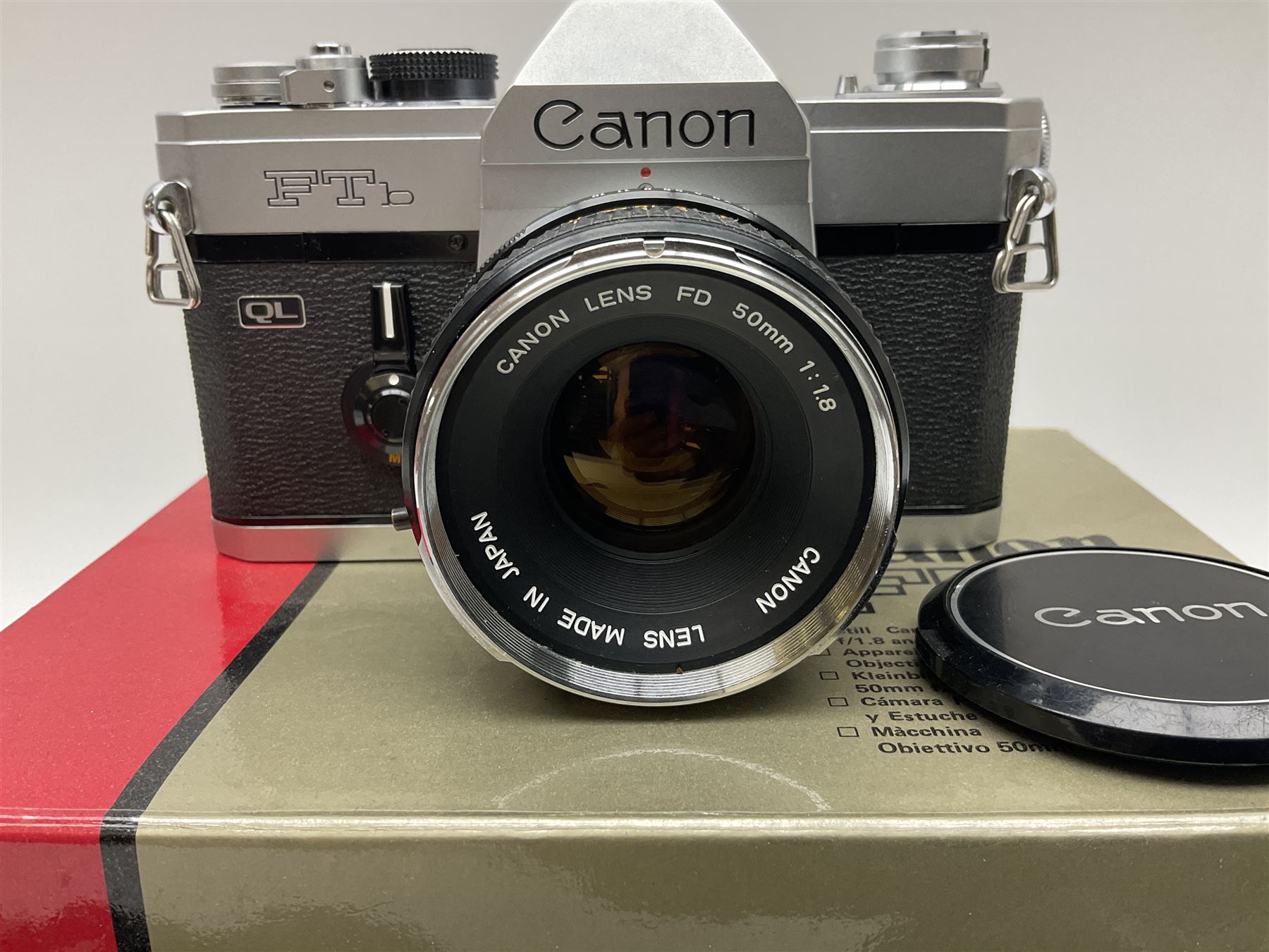 Canon FTb camera body, serial no. 715838, with 'Canon FD 50mm 1:1.8' lens, serial no. 207888, in original box, together with Canon FTb camera body, serial no. 557817, with 'Canon FD 35mm 1:3.5 S.C' lens, serial no. 126210 and Canon EX Auto camera body, serial no. 296244 with 'Canon EX 50mm 1:1.8' lens, serial no. 380869  
