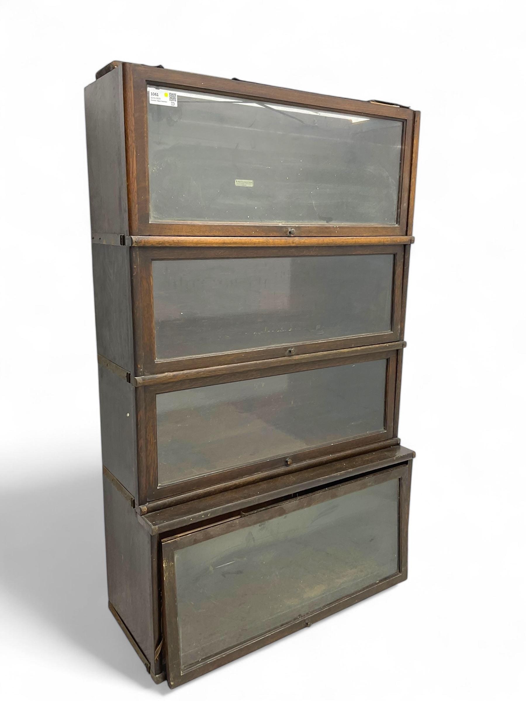 Globe Wernicke - early 20th century oak four-tier stacking library bookcase, four glazed sections enclosed by hinged and sliding doors