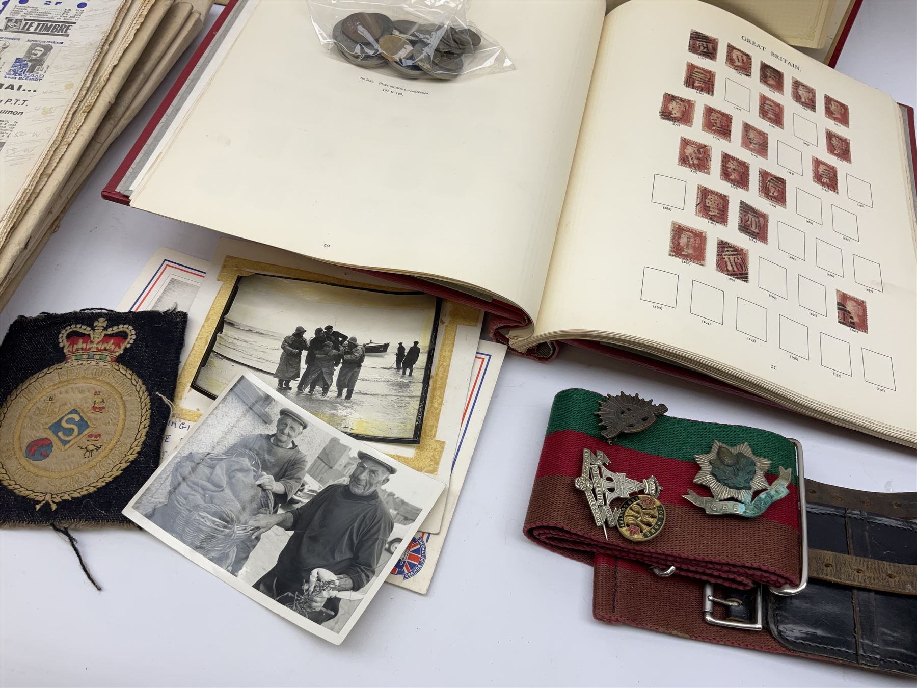 Great British and World stamps in two albums including a small number of Queen Victoria penny red stamps, small number of coins and various items of militaria interest