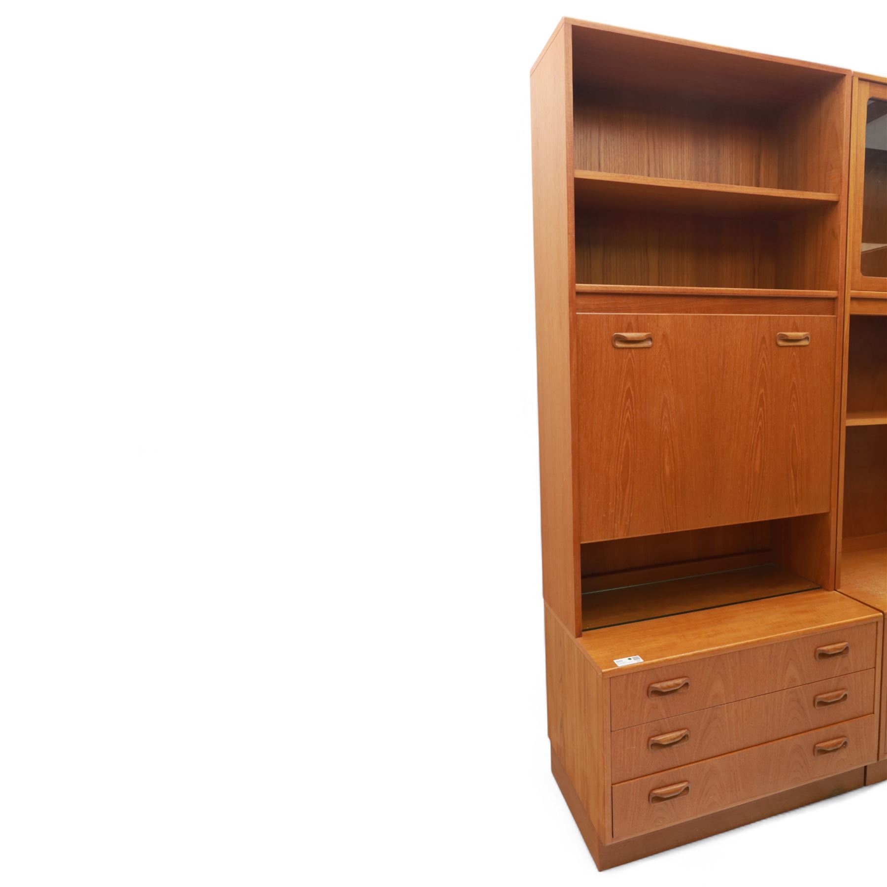 G Plan - Mid 20th century teak sectional wall cabinet, comprising six modular units including a fall front bureau, glazed display cabinet, open bookcase, cupboard and drawer bases, each with recessed handles and flush plinths