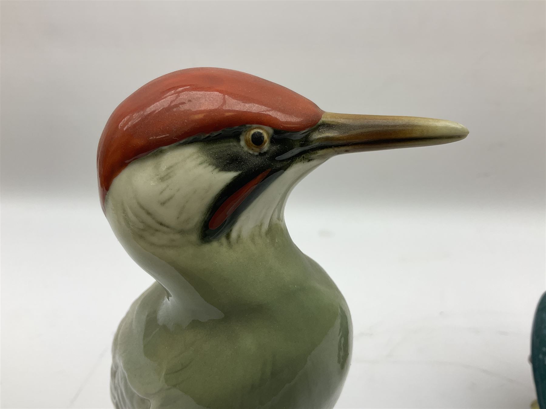 Karl Ens figure of a green woodpecker, modelled perched upon branch, model no. 7527, together with Karl Ens figure of budgie and Beswick Kingfisher no. 2371, all with printed marks beneath, tallest H25cm