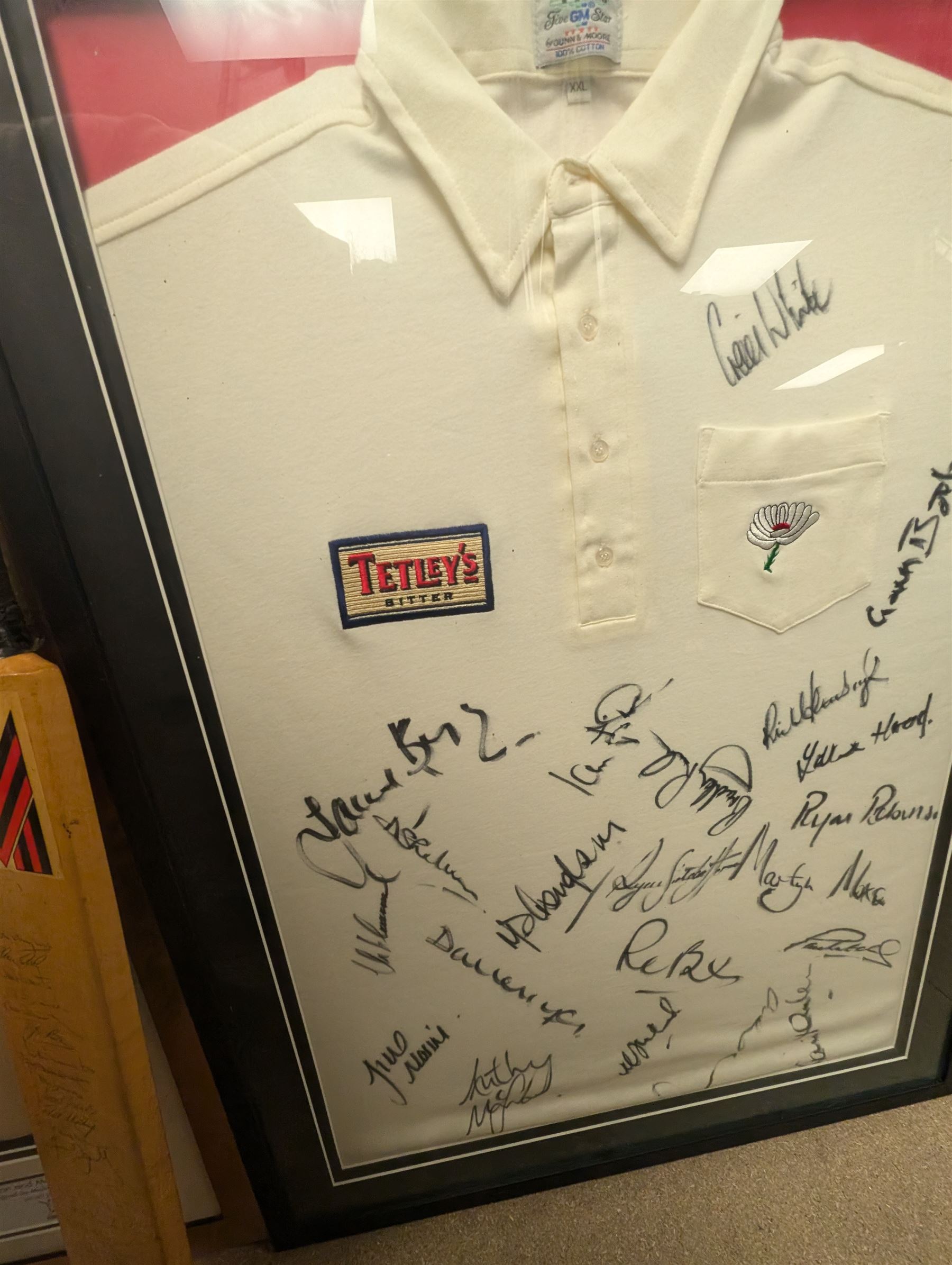 Signed England and Yorkshire cricket memorabilia, including framed bat signed by Michael Vaughn, signed photograph of England team, signed Yorkshire shirt and a signed bat