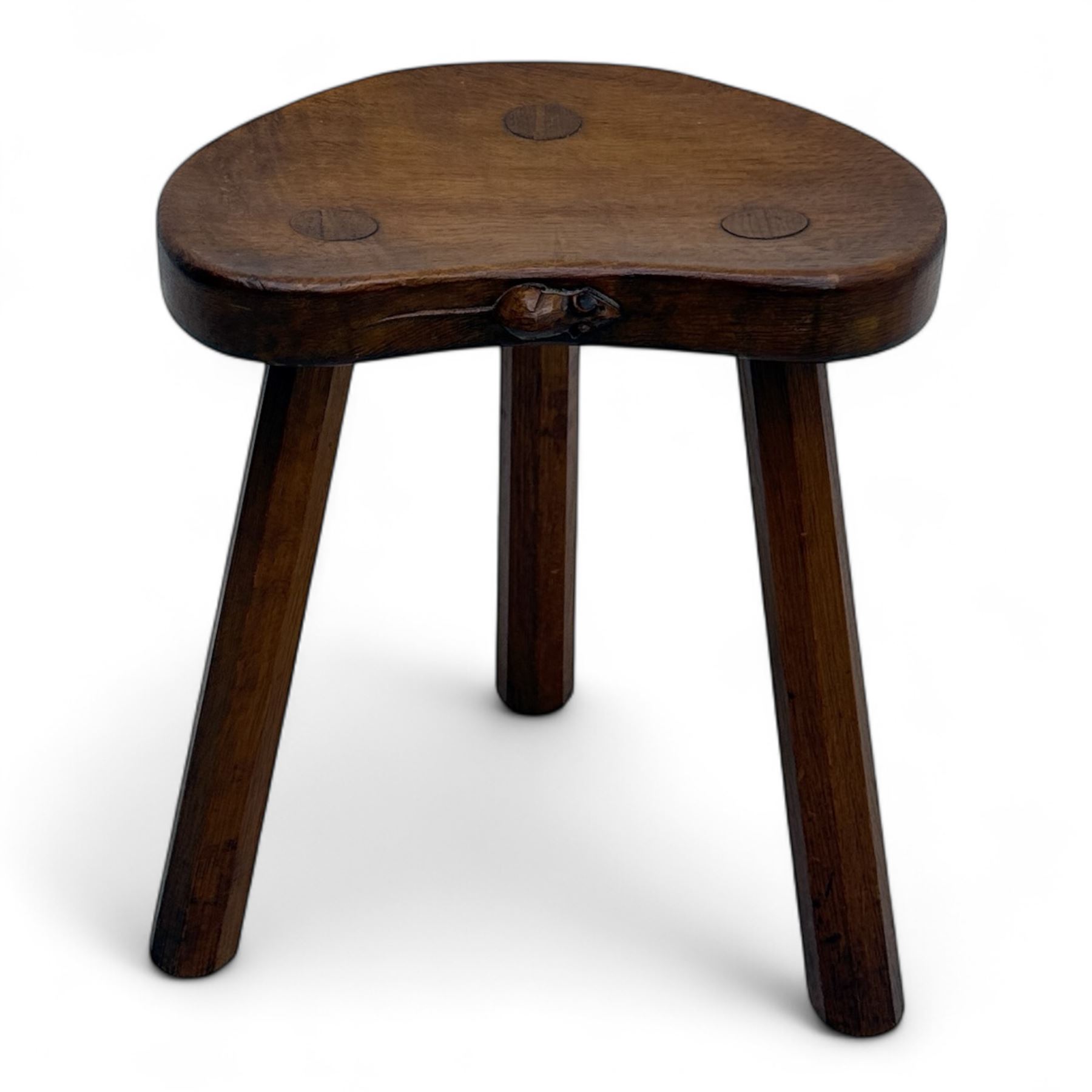 Mouseman - oak three-legged calf stool, kidney-shaped seat carved with the signature mouse motif, by the workshop of Robert Thompson, Kilburn