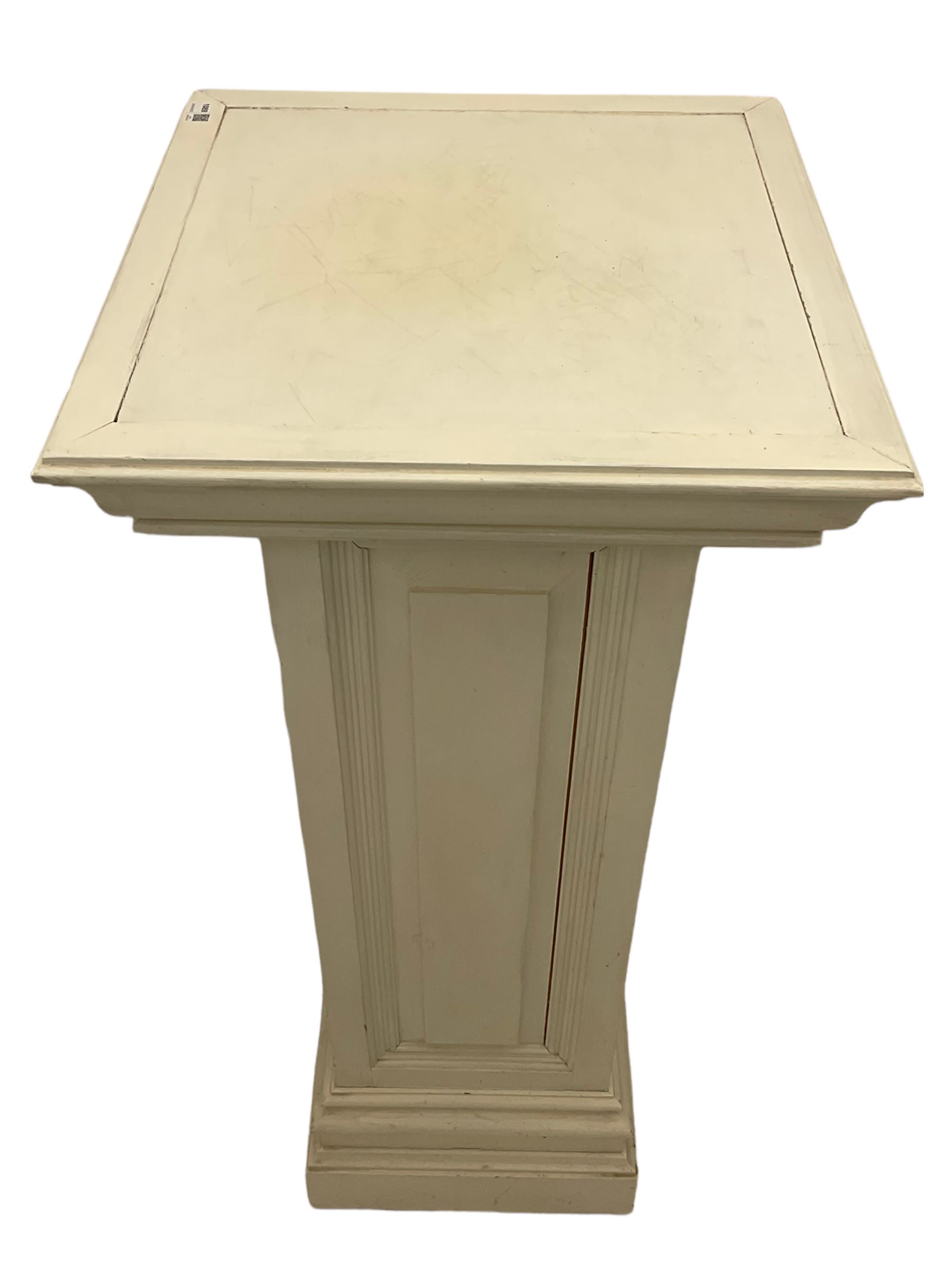 White painted pine pedestal plinth, the square moulded top over panelled rectangular body, stepped and moulded plinth base