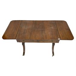 Regency rosewood sofa table, drop leaf rectangular top with rounded corners, fitted with two drawers and two opposing false drawers, raised on dual turned columns terminating in splayed feet united by turned stretcher, on brass cups and castors